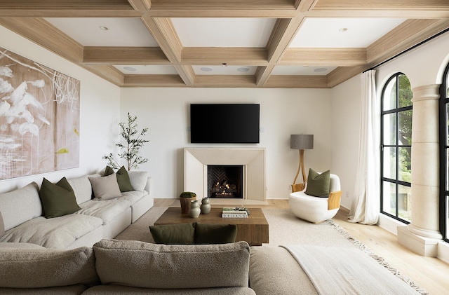 living room featuring beamed ceiling and coffered ceiling