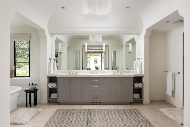 bathroom with tile patterned flooring, vanity, and a bathtub