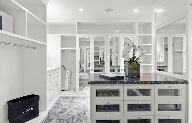 spacious closet with light colored carpet