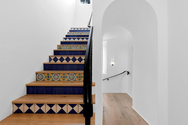 staircase featuring wood-type flooring