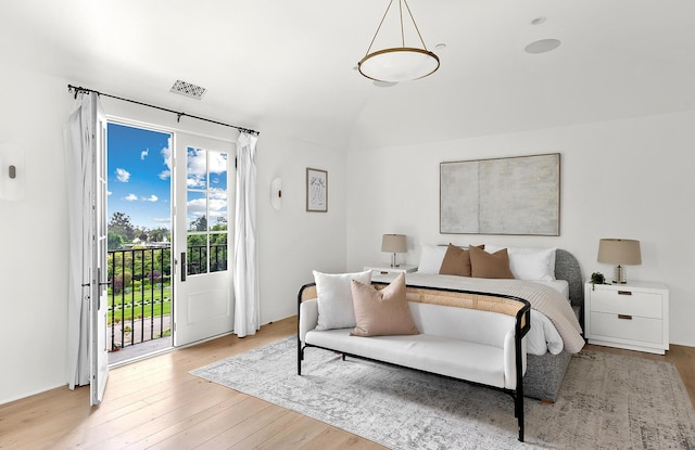 bedroom featuring access to exterior and light hardwood / wood-style flooring