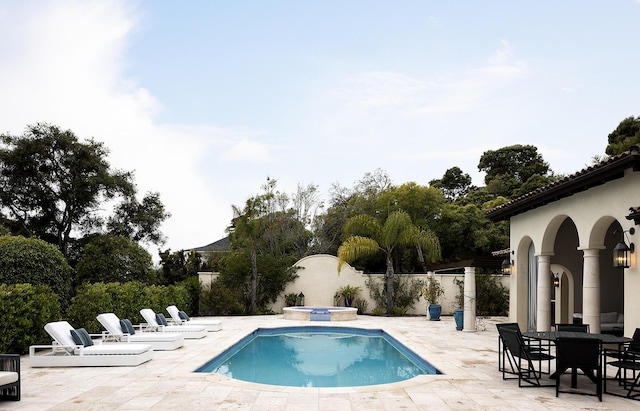 view of swimming pool with an in ground hot tub and a patio