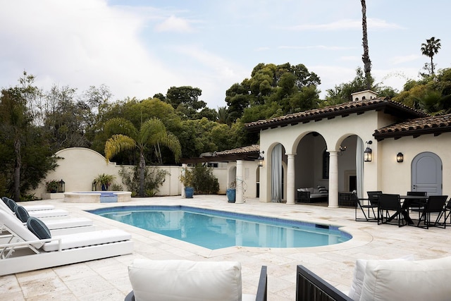 view of swimming pool featuring an in ground hot tub and a patio