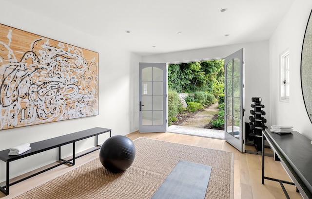 entryway with french doors and light hardwood / wood-style flooring