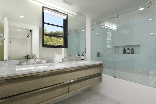 bathroom featuring vanity and combined bath / shower with glass door