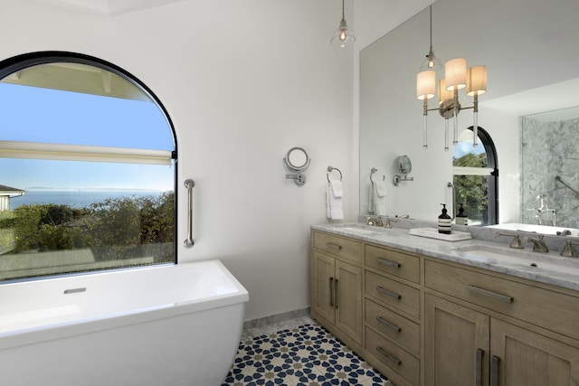 bathroom with vanity, a bath, and a water view