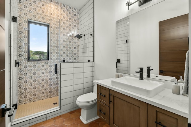 bathroom with tile patterned floors, a shower stall, toilet, and vanity