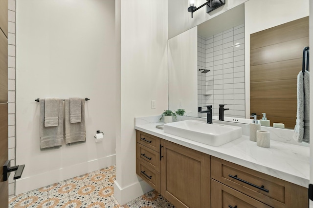 full bathroom featuring vanity, baseboards, and walk in shower