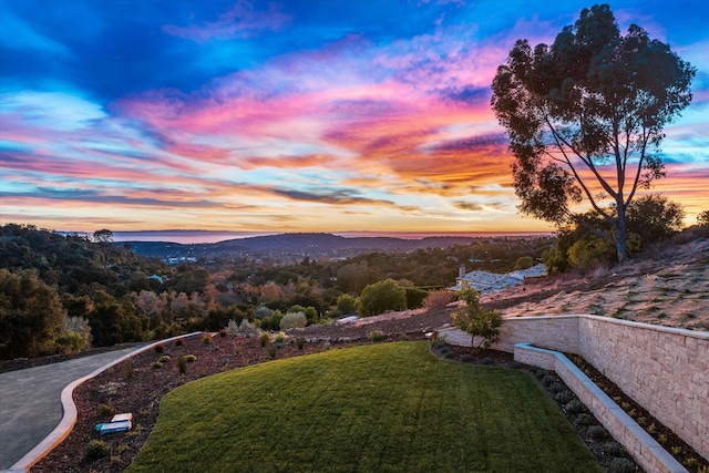 yard at dusk featuring a mountain view