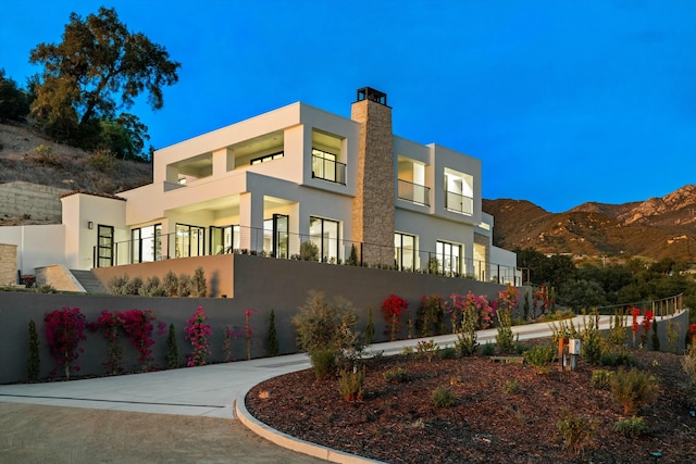 exterior space with a mountain view and fence