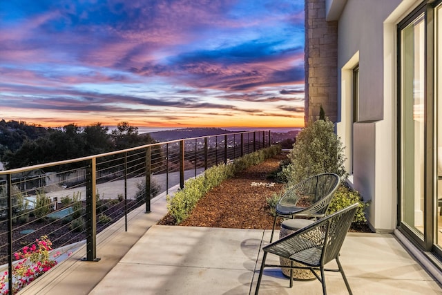 view of balcony at dusk