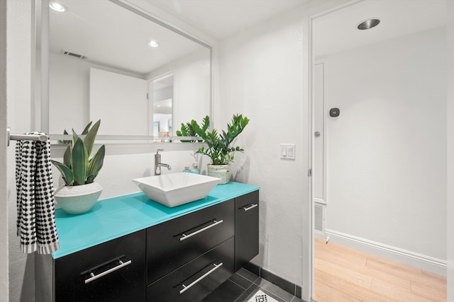 bathroom with hardwood / wood-style flooring and vanity