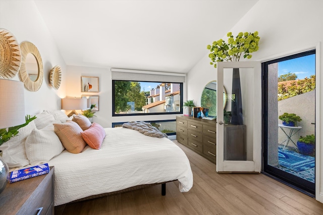 bedroom with lofted ceiling, access to outside, multiple windows, and light hardwood / wood-style floors