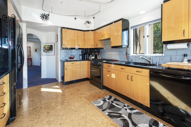 kitchen with sink, tasteful backsplash, and black appliances