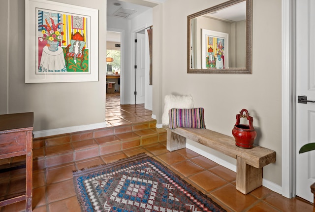 corridor with dark tile patterned flooring