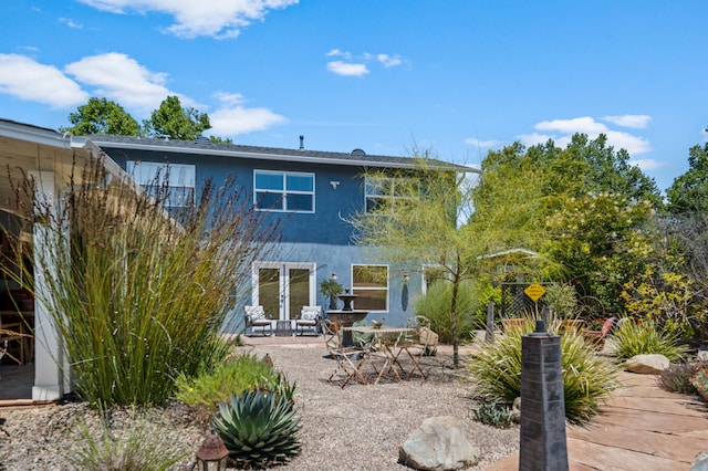 rear view of property featuring a patio area and french doors