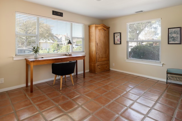 tiled office space featuring a healthy amount of sunlight