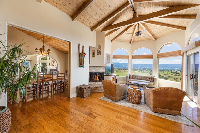 2408 Latigo Dr, Solvang, CA 93463 - living room featuring beamed ceiling, ceiling fan with notable chandelier, light hardwood / wood-style flooring, and wooden ceiling