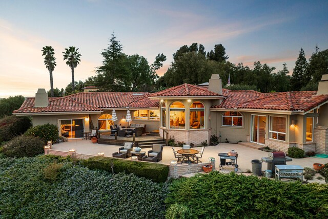 2408 Latigo Dr, Solvang, CA 93463 - back house at dusk with an outdoor living space and a patio