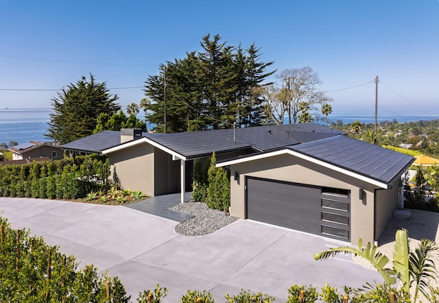 ranch-style home featuring a garage, concrete driveway, and stucco siding
