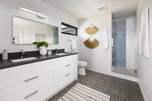 full bathroom featuring speckled floor, a shower stall, visible vents, and a sink