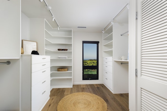 walk in closet with wood finished floors and visible vents