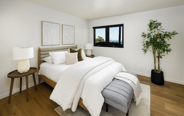 bedroom with wood finished floors and baseboards
