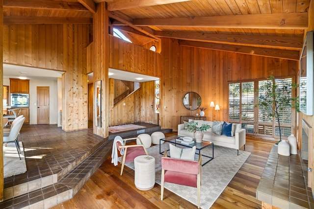 living room with beamed ceiling, hardwood / wood-style flooring, high vaulted ceiling, and wood ceiling