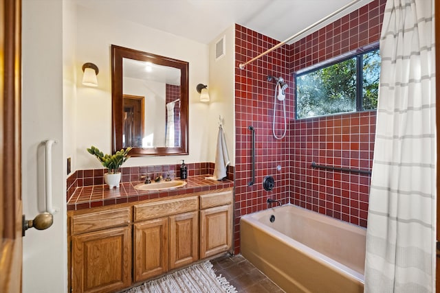 bathroom with tile patterned floors, vanity, and shower / tub combo with curtain