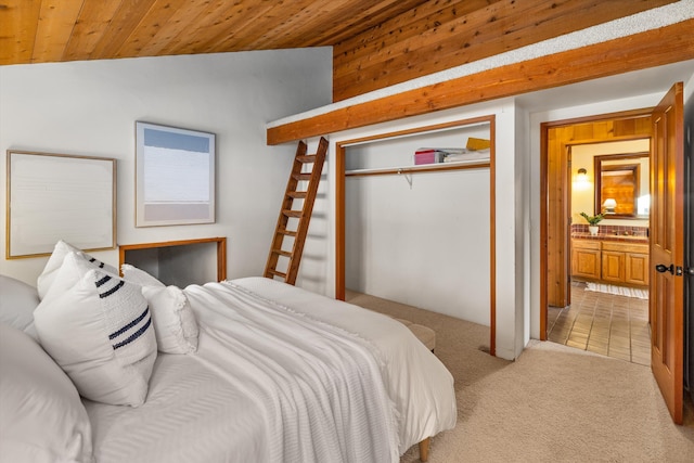 carpeted bedroom featuring a closet, lofted ceiling, and wood ceiling