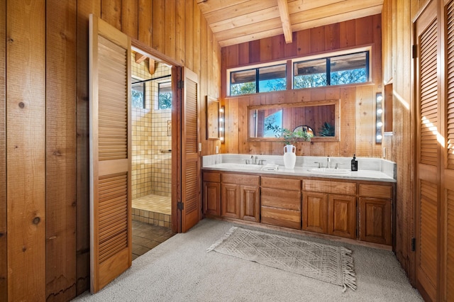 bathroom with vanity, lofted ceiling with beams, wooden walls, and wood ceiling