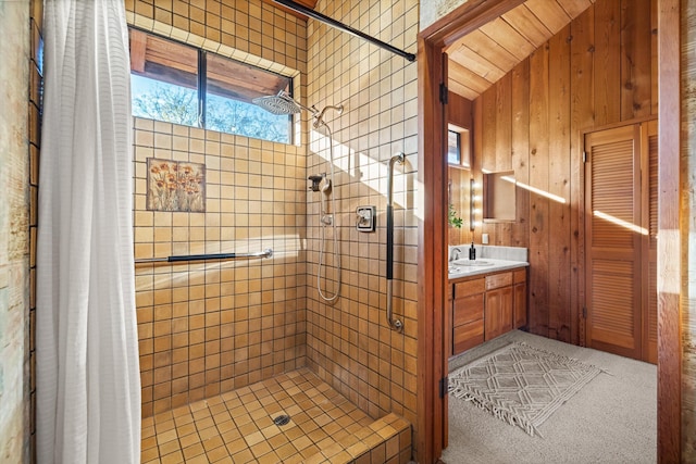 bathroom featuring vanity, walk in shower, and lofted ceiling