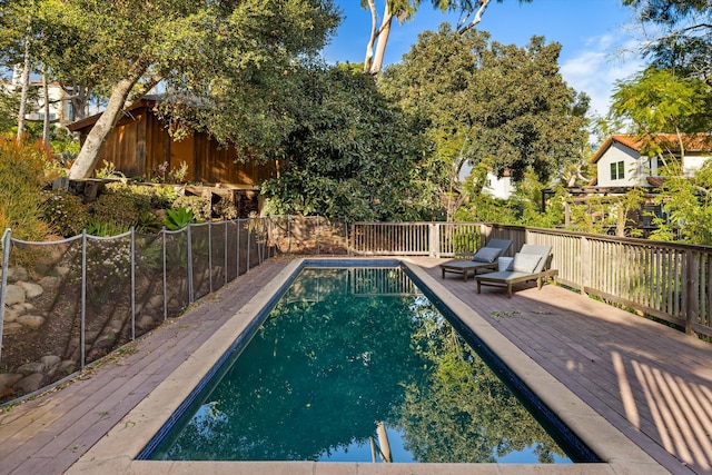 view of swimming pool featuring a wooden deck