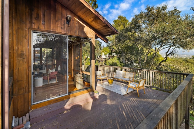 deck featuring a sunroom and an outdoor living space