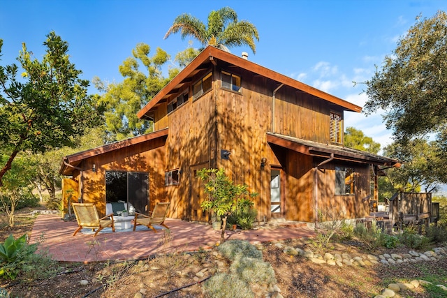 rear view of property featuring a patio area