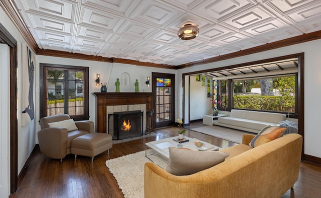 living room with a tiled fireplace and dark wood-type flooring