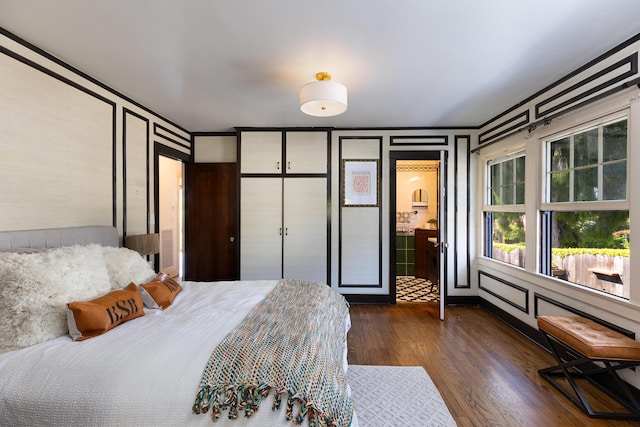 bedroom with dark hardwood / wood-style flooring