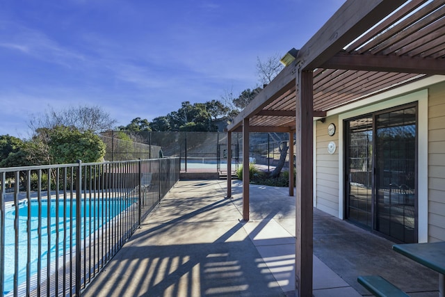 view of swimming pool with a pergola and tennis court