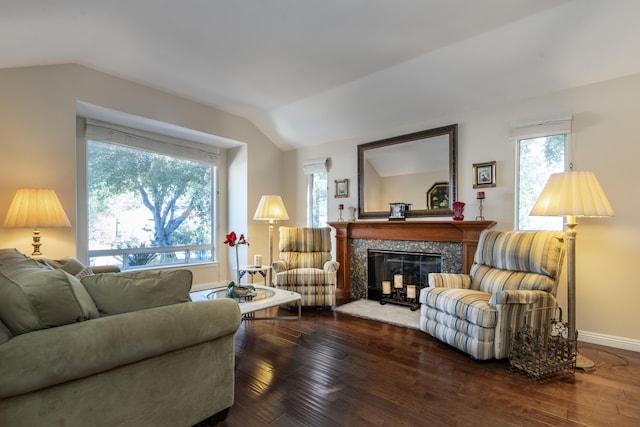 sitting room featuring dark hardwood / wood-style floors, a high end fireplace, and vaulted ceiling