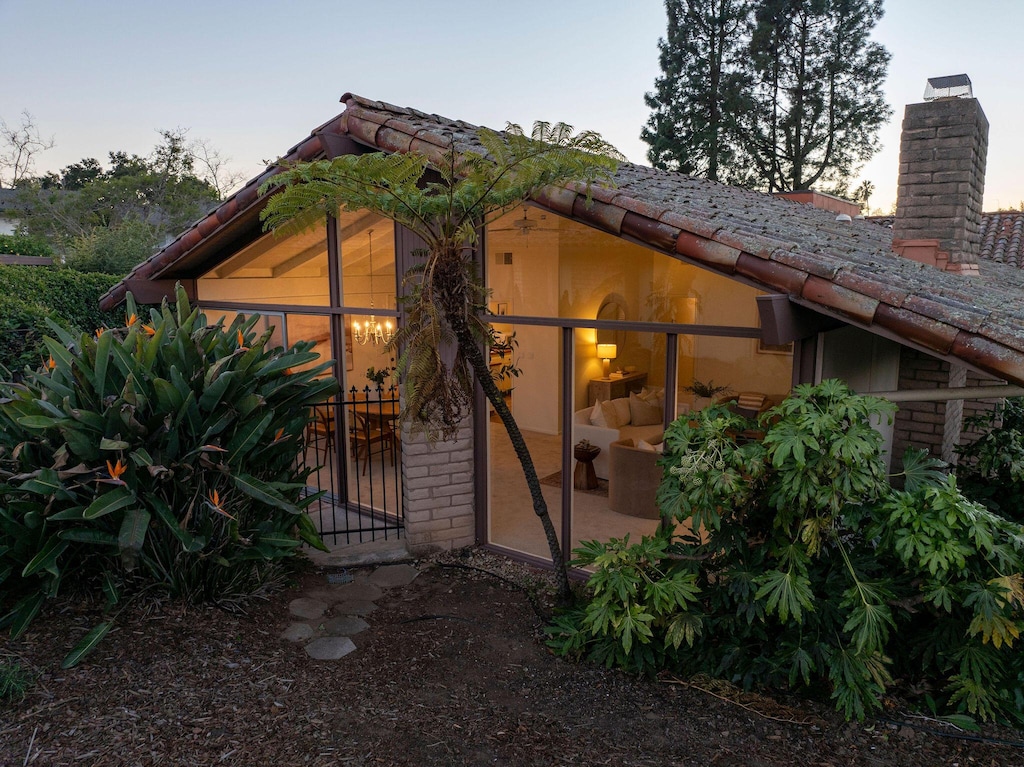 property exterior at dusk featuring a patio