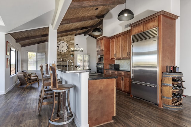 kitchen with wooden ceiling, dark wood-type flooring, beam ceiling, kitchen peninsula, and stainless steel appliances