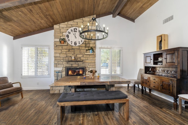 dining room featuring beam ceiling, a fireplace, a chandelier, and dark hardwood / wood-style floors