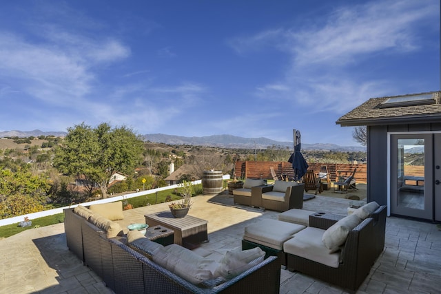 view of patio featuring a mountain view and an outdoor living space