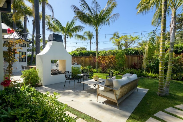 view of patio with an outdoor living space with a fireplace