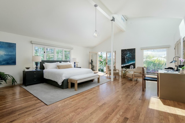 bedroom with beamed ceiling, high vaulted ceiling, and light hardwood / wood-style flooring