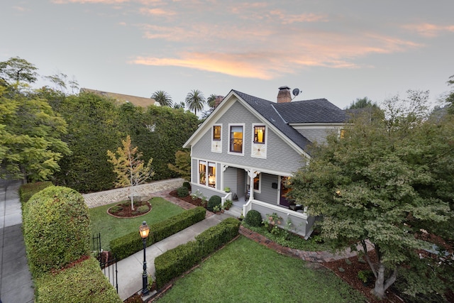 view of front of house featuring a lawn and a porch