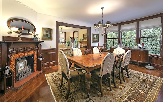 dining area with dark hardwood / wood-style floors, a chandelier, and a fireplace