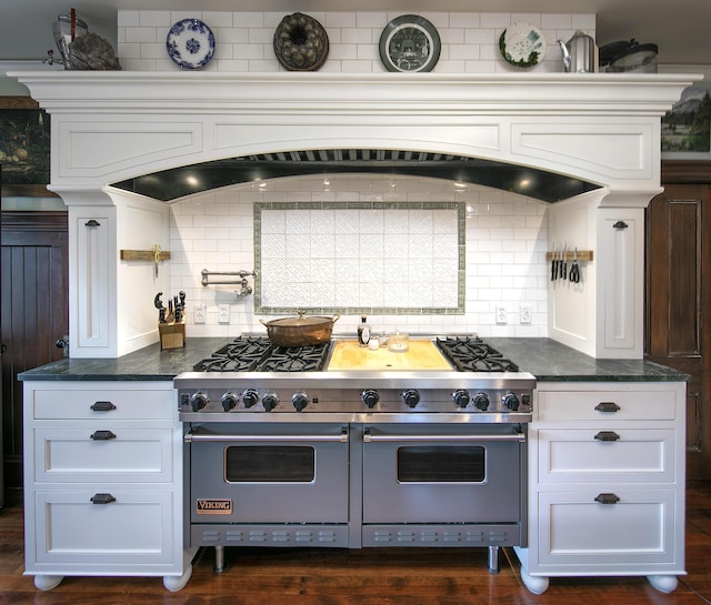 kitchen with white cabinets, double oven range, and decorative backsplash