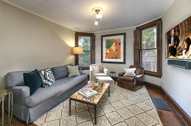 living room featuring light wood-type flooring, ornamental molding, and plenty of natural light