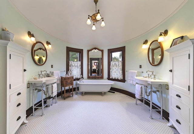 bathroom with a bathtub and double sink